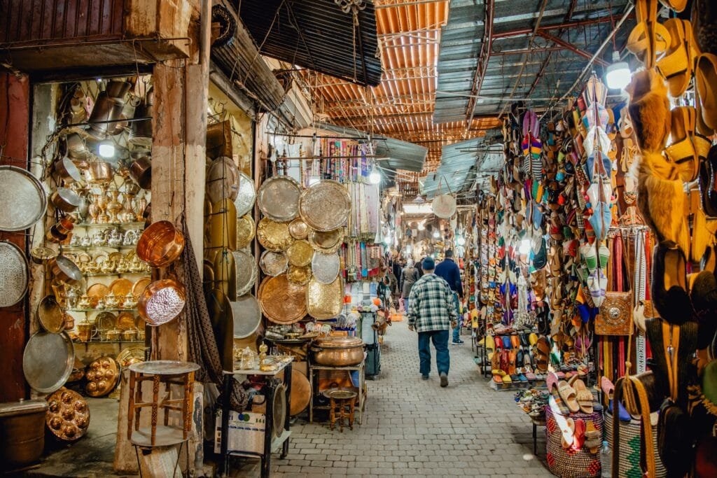 Lantern and metalwork stalls in a covered souk in the Marrakech medina